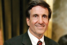 Randy Holland ’69—Judicial Ethicist is a man with brown hair who smiles. 